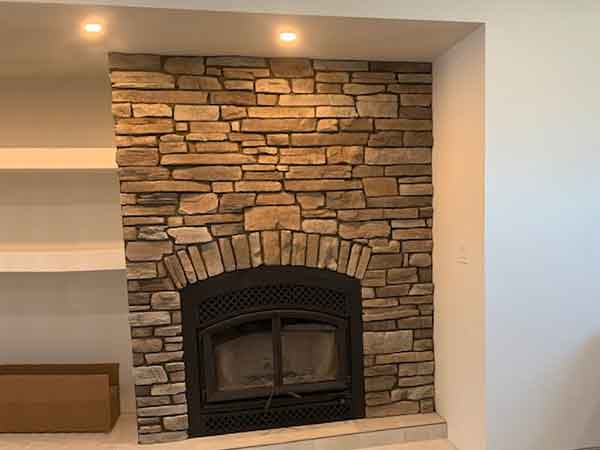 Fireplace veneer stone installation, Southern Manitoba